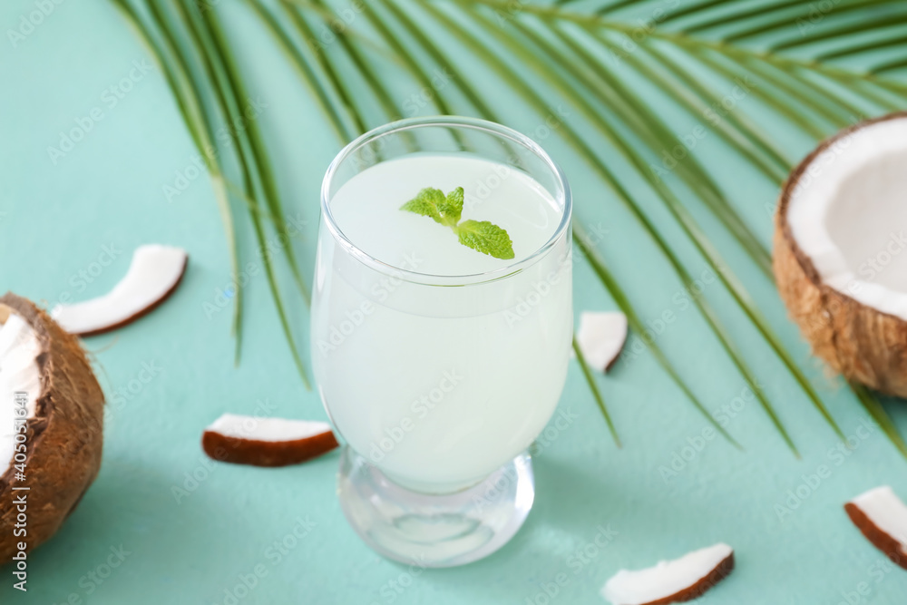 Glass of fresh coconut water on color background Glass of fresh coconut water on color background