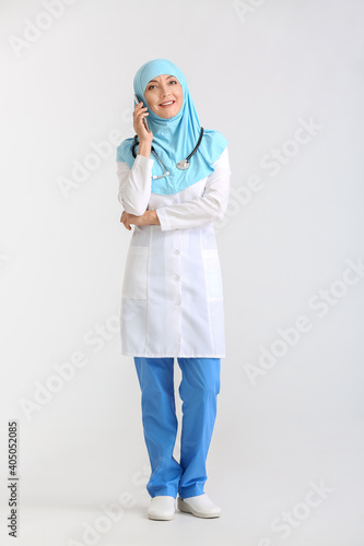 Smiling muslim female docto...