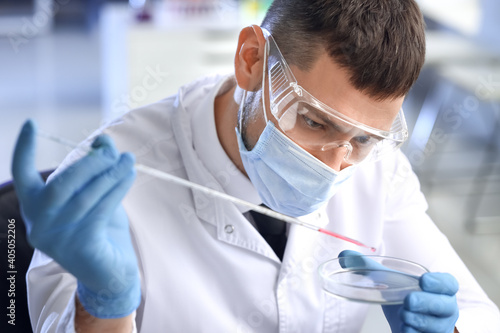 Scientist working with sample in laboratory