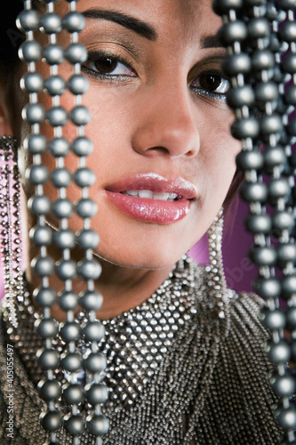 Close up of Hispanic woman and beaded curtain photo