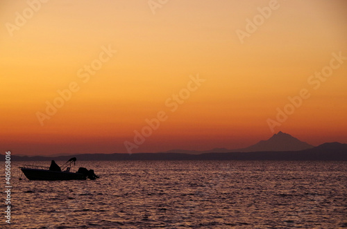 fishing boat at dawn against the backdrop of the holy Mount Athos