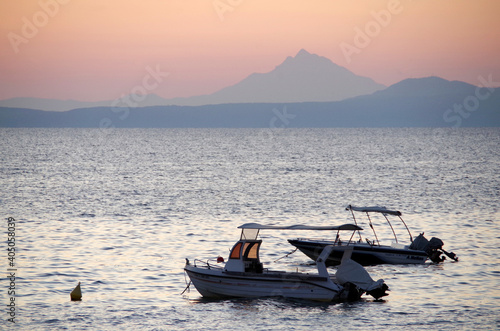 two fishing boats at dawn against the backdrop of the holy Mount Athos © dafna_nb