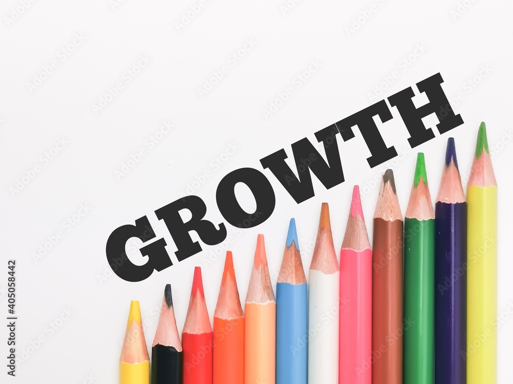 Text GROWTH written on white background with colorful pencil.Education and business concept. Text GROWTH written on white background with colorful pencil.Education and business concept.