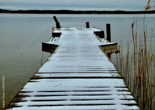 Wooden Jetty On Pier Over Lake Against Sky