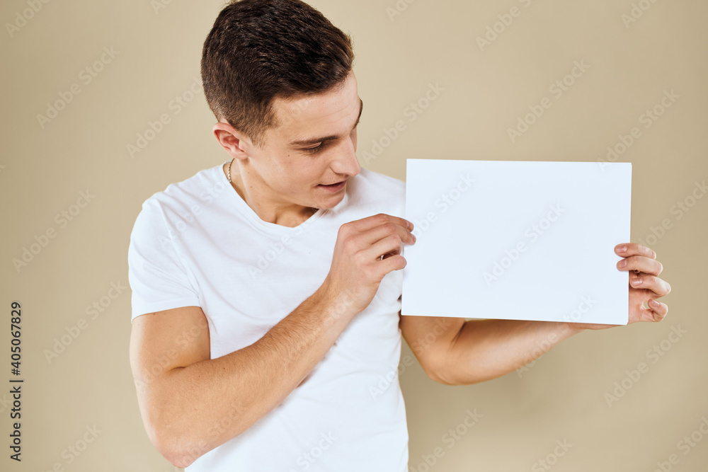 man in white t-shirt sheet of paper in hands Copy Space cropped view beige background man in white t-shirt sheet of paper in hands Copy Space cropped view beige background