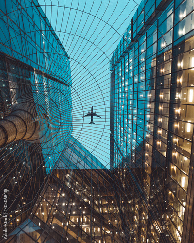 Wallpaper Mural Low-angle photo of commercial plane flying over buildings Torontodigital.ca