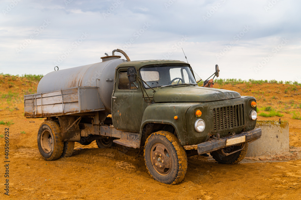 Truck with water tank in sand desert