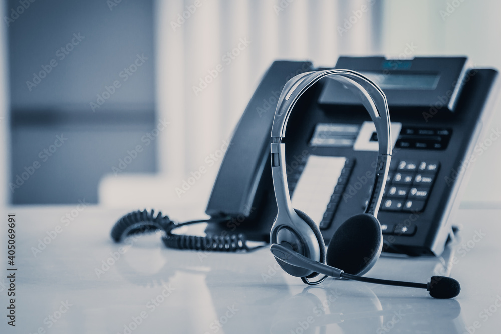 Communication support, call center and customer service help desk. VOIP headset on telephone keyboard. Communication support, call center and customer service help desk. VOIP headset on telephone keyboard.