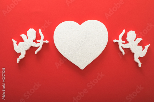 Flying cupid silhouette with hearts, gifts, happy Valentine's Day banners, paper art style. Amour on red paper