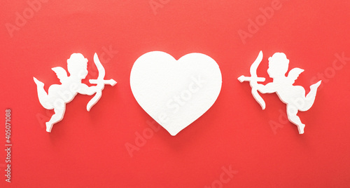 Flying cupid silhouette with hearts, gifts, happy Valentine's Day banners, paper art style. Amour on red paper