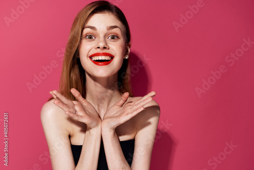 Cute cheerful woman and red lips cosmetics emotions pink background
