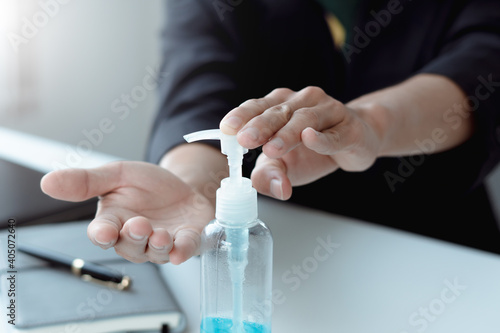 Man hands using wash hand alcohol gel or sanitizer bottle dispenser, against Novel coronavirus or Coronavirus Disease (Covid-19) .