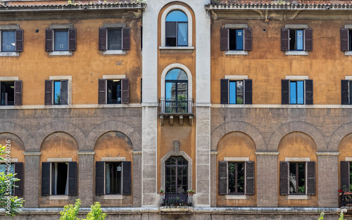 vintage residential building "palazzo" facade symmetric windows, Rome Italy