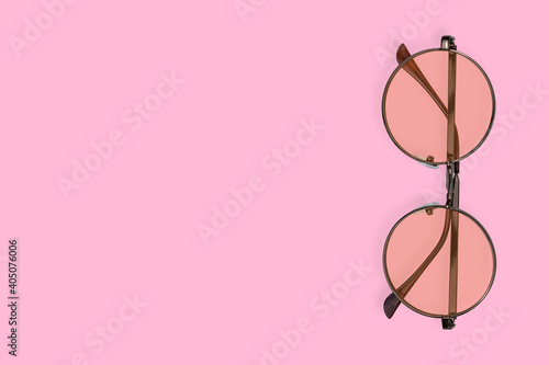 Glasses for improving vision with on a pink background.