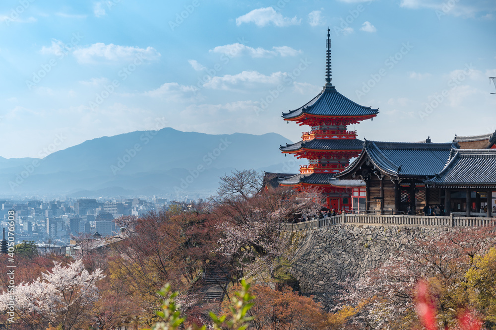 The red pagoda in Kiyomizu temple or Kiyomizudera and cherry blossom in foreground, the famous travel place of Kyoto, Japan. The red pagoda in Kiyomizu temple or Kiyomizudera and cherry blossom in foreground, the famous travel place of Kyoto, Japan.