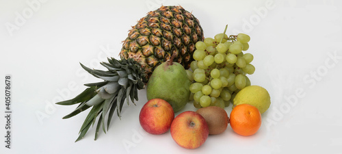 arrangement of different fruits on white background with copy-space