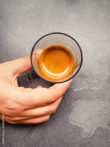 top view of a hand holding a cup of coffee