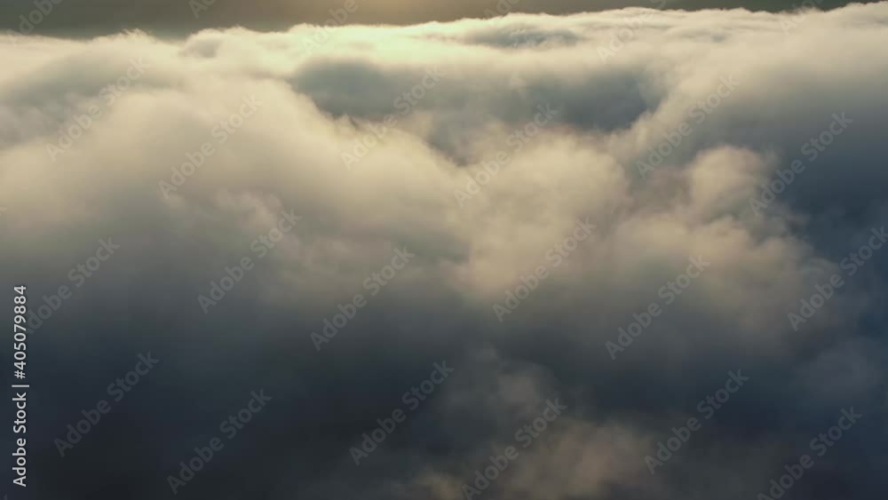 flight over clouds that are illuminated by sunlight flight over clouds that are illuminated by sunlight