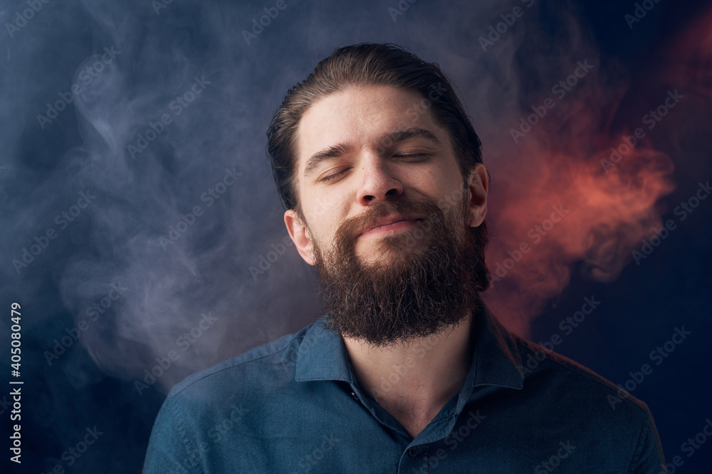 Emotional man black shirt attractive look close-up smoke in the background Emotional man black shirt attractive look close-up smoke in the background