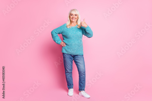 Full length photo of old lady raise thumb up wear blue pullover jeans footwear isolated pink pastel color background