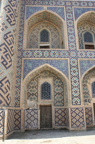 Bukhara, Uzbekistan - November 25 2019: Abdulaziz Khan madrasah, built in 1652. Beautiful decoration front facade of madrassah. 