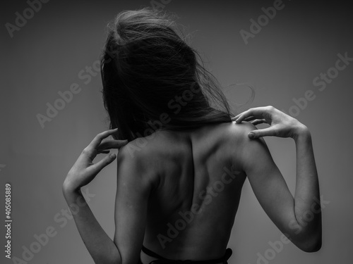 black and white photography portrait of woman with naked back cropped view and close-up