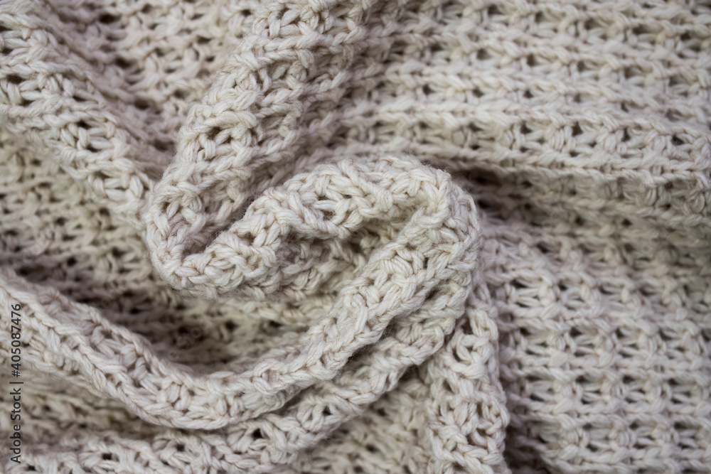 The texture of the knitted woolen thread in close-up.