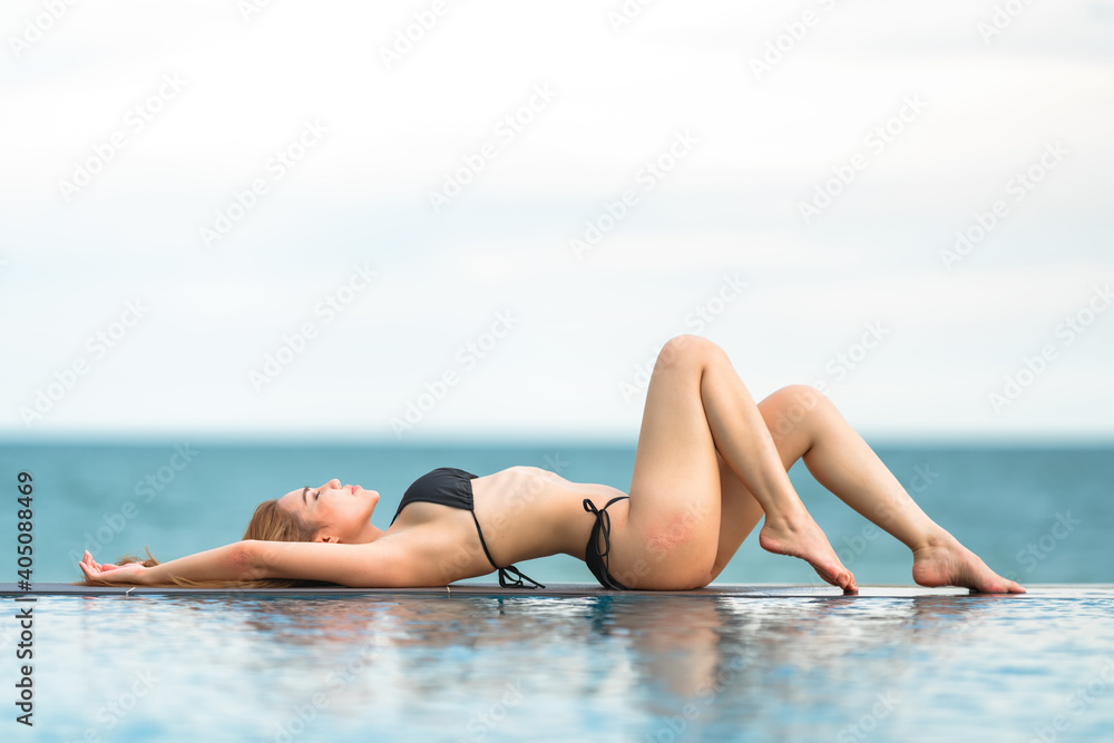 Beautiful Asian women or Thai women and black bikinis at the bar, relaxing at the beach for traveling in the summer concept Beautiful Asian women or Thai women and black bikinis at the bar, relaxing at the beach for traveling in the summer concept