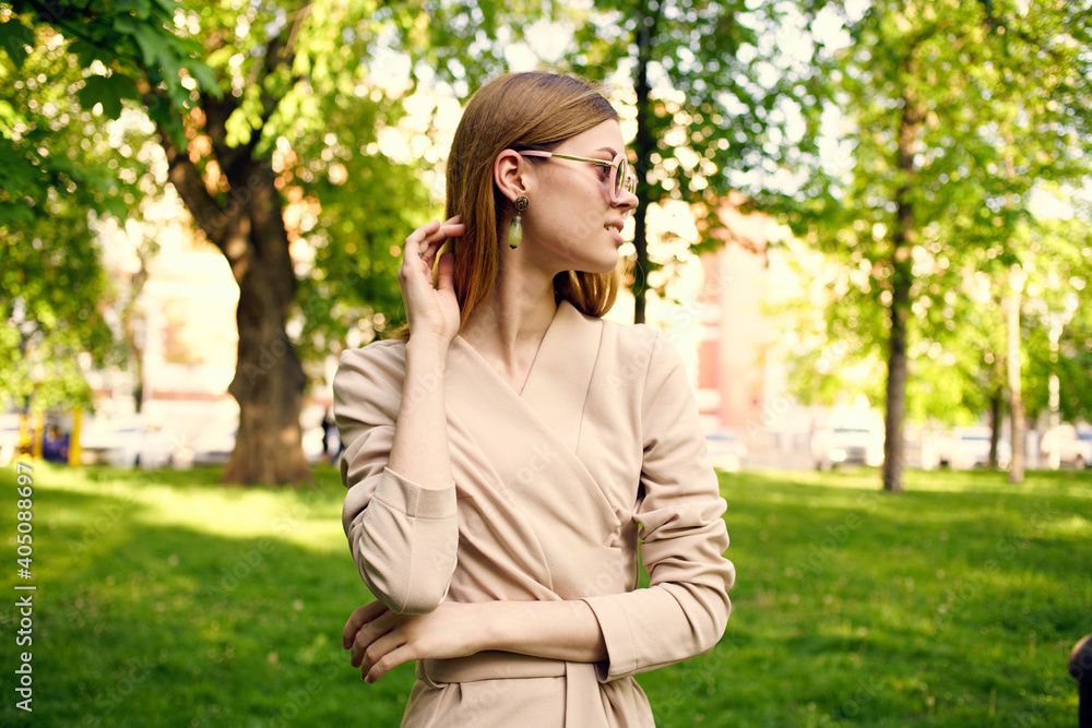 Cheerful pretty woman in sunglasses outdoors in the park Cheerful pretty woman in sunglasses outdoors in the park