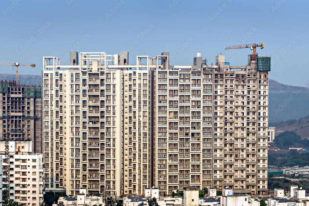 Twin, tall residential buildings under construction in Pune, Maharashtra, India.