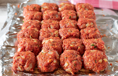 raw meat skewers with minced meat lined up