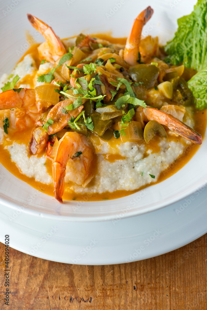 Shrimp and Grits. Grits and old bay seasoned jumbo shrimp topped with spices and micro greens. Classic American Diner Style Breakfast or Brunch menu item. Traditional low country southern staple. Shrimp and Grits. Grits and old bay seasoned jumbo shrimp topped with spices and micro greens. Classic American Diner Style Breakfast or Brunch menu item. Traditional low country southern staple.