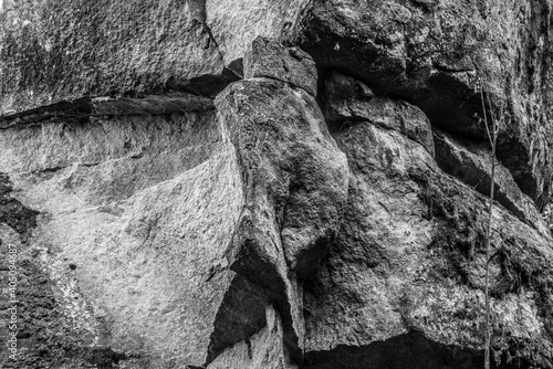 Schwarz weiß Foto der mystische Felsengruppe und Steingruppe Teufelsstein bei der Teufelsmühle bei Rattenberg mit dem Felsengesicht einem Gesicht oder Fratze eines Teufelsgesichts  photo