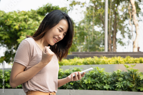 Successful happy asian woman with smartphone, concept of online shopping, distant togetherness, online deal, smartphone app transaction, new normal work via video call, social distancing