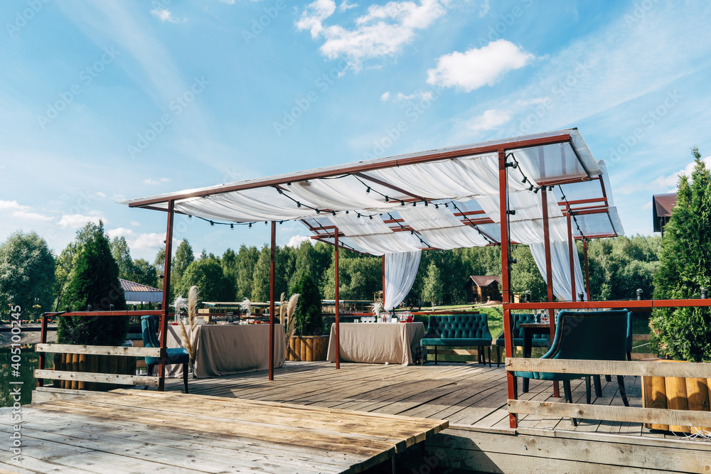 Terrace beside lake in warm summer evening, luxury catering. Terrace beside lake in warm summer evening, luxury catering.