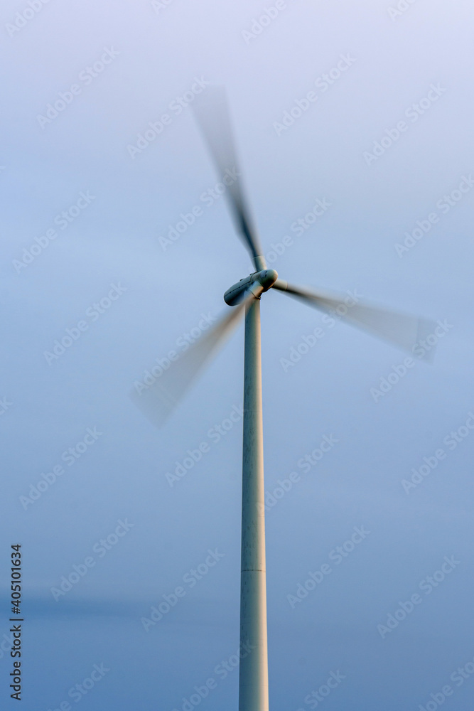 Green wind energy, windmill close up in action, converting wind into energy. Green wind energy, windmill close up in action, converting wind into energy.
