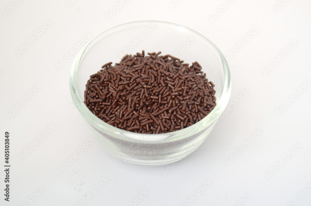 Chocolate Meses, meises, in a glass bowl. Isolated white background Chocolate Meses, meises, in a glass bowl. Isolated white background