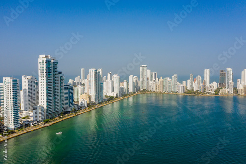 Skyscraper with white facades at a bright sunny day on the blue sky background. Economy finances and business activity concept aerial view © ronedya