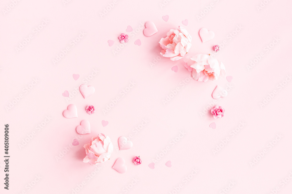 Valentine's Day background. Wreath made of pink flowers, hearts on pastel pink background. Valentines day concept. Flat lay, top view, copy space