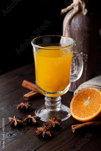 Seasonal vitamin orange tea with honey, a perfect natural cold treatment, with a fresh croissant, close up