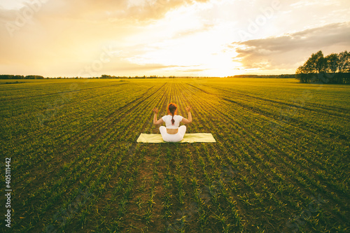 Obraz na plátne Curvy girl doing yoga in nature.