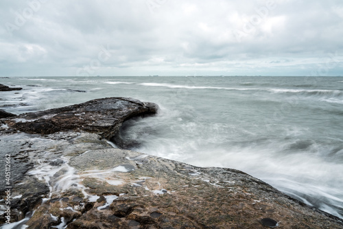 Wave splashing at the rocks, long exposure