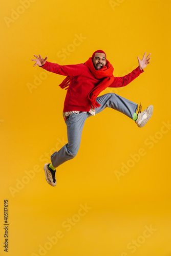 Excited happy african man wearing scarf having fun