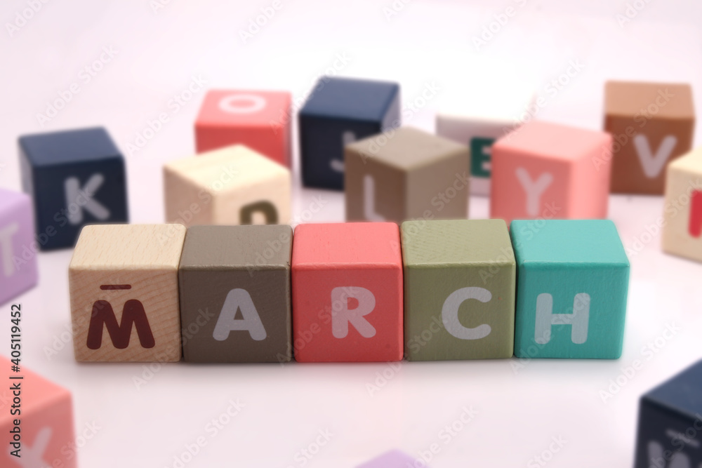 Cubes each with a letter on it written the word march Cubes each with a letter on it written the word march