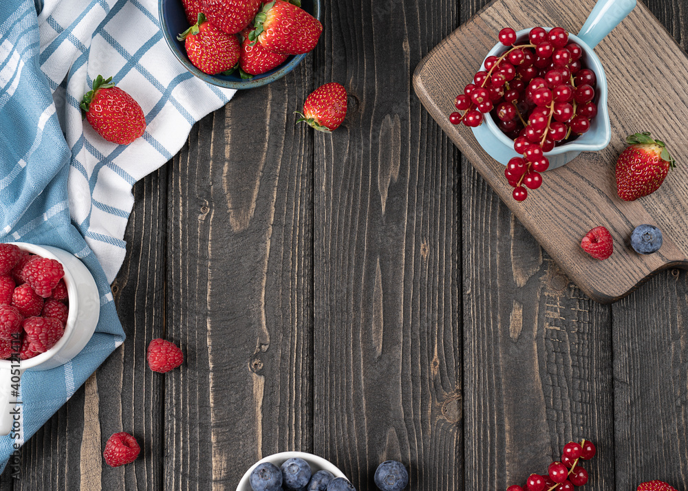 Strawberries, red currants, blueberries and raspberries on a wooden background with copy space Strawberries, red currants, blueberries and raspberries on a wooden background with copy space