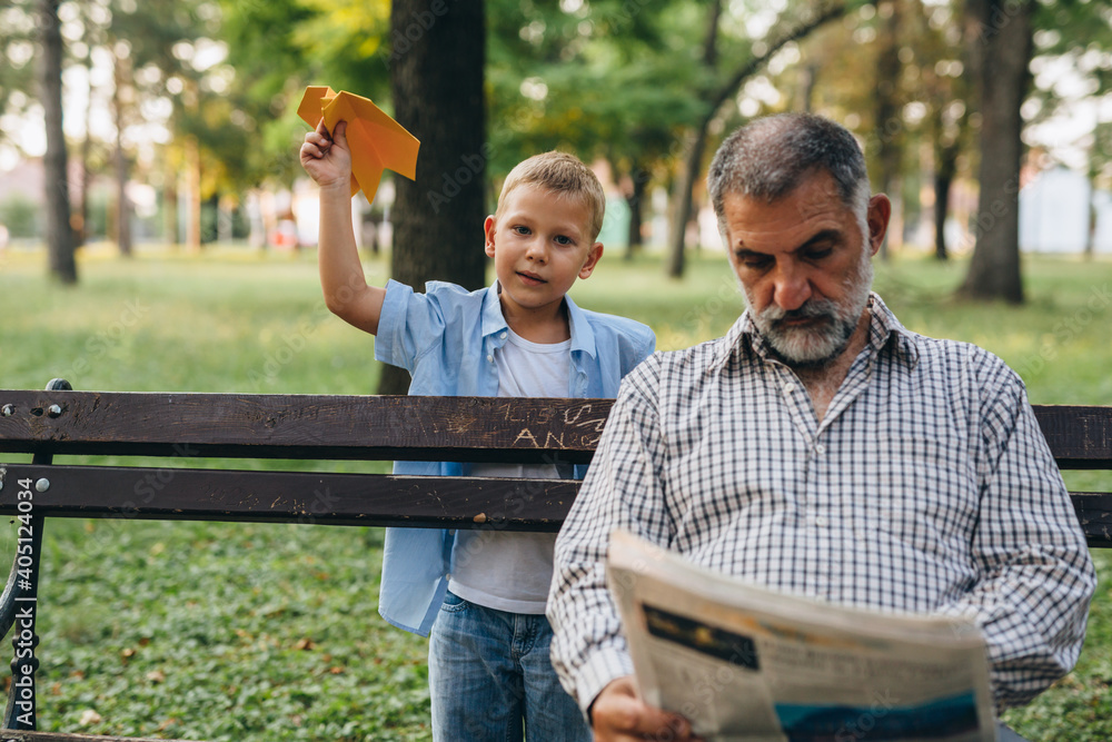 Fototapeta premium grandfather and grandson enjoying time in public park