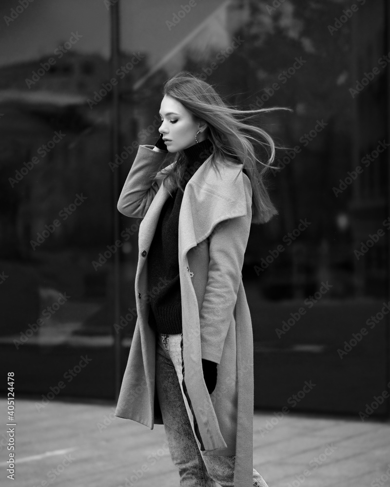Woman in the city in a coat bw