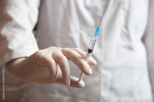 medical injection syringe in the nurse's hand