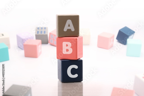 letters ABC on small wooden blocks standing on top