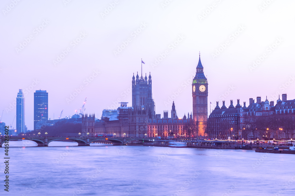 dusk landmark of london westminister parlaiment building across thames river with plain sky background